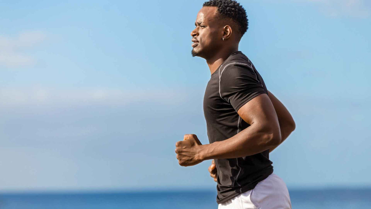 A man running beside the sea.